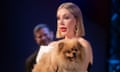Katherine Ryan holding a pomeranian dog in her arms in Silence is Golden, with Dermot O'Leary blurred out in the background