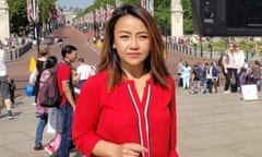Patsy Widakuswara, an Indonesian-American woman wearing a red cardigan on The Mall in London