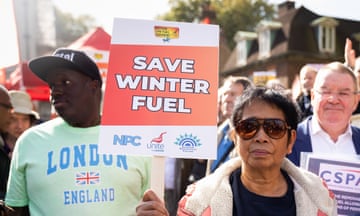 Campaigners on the street, one holding Save Winter Fuel placard