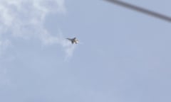 An Israeli fighter jet fires a rocket as it flies over an area near the Syrian capital, Damascus