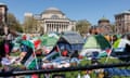 tents on lawn in front of white building