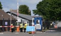 Staff in hi-vis jackets guard the entrance to the Manston immigration short-term holding facility