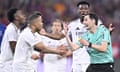 Real Madrid players harass referee Ricardo De Burgos Bengoetxea during a turbulent Copa del Rey final against Barcelona
