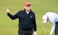 Trump wearing red Maga cap gestures with golfer bending behind on  green