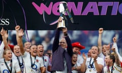 England head coach John Mitchell lifts the Six Nations trophy after his side beat France 43-42 at Twickenham.