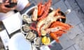 An overhead shot of a table with a platter of seafood