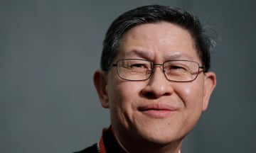 FILE - Cardinal Luis Tagle smiles as he listens reporters questions during a press conference on the Synod at the Vatican, Tuesday, 23 Oc, 2018. 