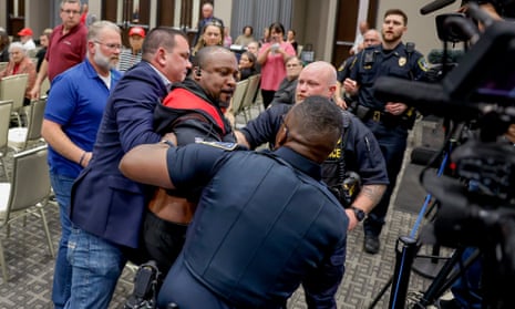 Police use Taser on protester at Marjorie Taylor Greene town hall – video