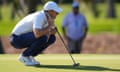 Rory McIlroy crouches to line up a putt at the Zurich Classic