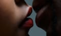 Two pairs of lips about to kiss.