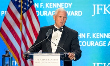 Man in tuxedo accepts award on stage