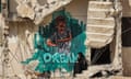 A woman sits along the broken steps of a partially-collapsed building destroyed by bombardment during the May 2021 confliict between Hamas and Israel, next to a graffiti mural depicting a girl with an English caption below reading "I've dream", in Gaza City on 12 August 2021.