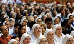 People, mostly nuns, sitting in rows facing in the same direction