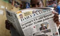 A man reads a newspaper reporting the impact of the US government aid freeze on Kenya and the rest of Africa.