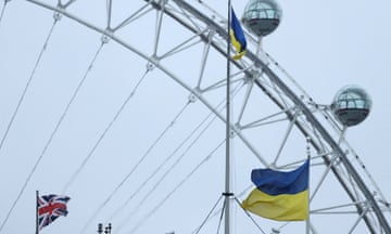 Ukrainian flag and Union Jack fly on building close to the London Eye