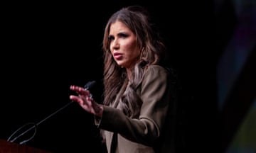 a woman speaks into a microphone with hand gestured