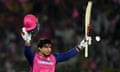 Vaibhav Suryavanshi holds his bat and helmet aloft after becoming the youngest player to score an IPL century