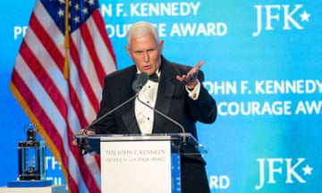Man in tuxedo accepts award on stage