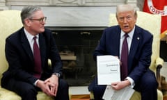 two men in suits sitting in chairs