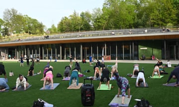 A free Yoga class on the artifical grass surface ioutside the new Davis Center.
