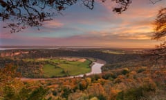 a winding river in a landscape with autumn foliage