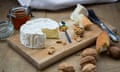 Camembert, bread, walnuts and honey on wood
