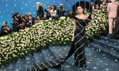 Demi Moore is on theme in a black and white gown by Thom Browne resembling a necktie