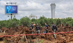 Israeli security services inspect a crater near a road outside Ben Gurion airport