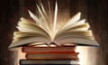 stack of books with the top one fanned open
