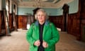 Claire Malcolm in a bright green hooded jacket inside an old hall