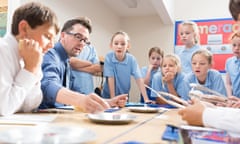 Teacher and students gathered around a table