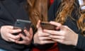 teenage school girls on their phones